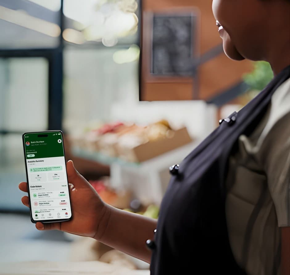 A business owner checking the Bizlo app on their phone
