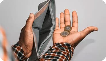 An open wallet holding a few coins