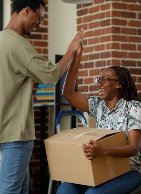 Two people celebrating a delivery with a high five